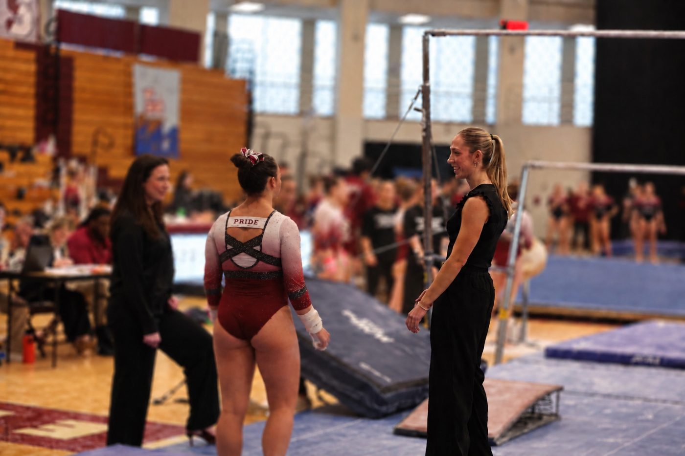 Sophia LeBlanc coaching at a gymnastics meet